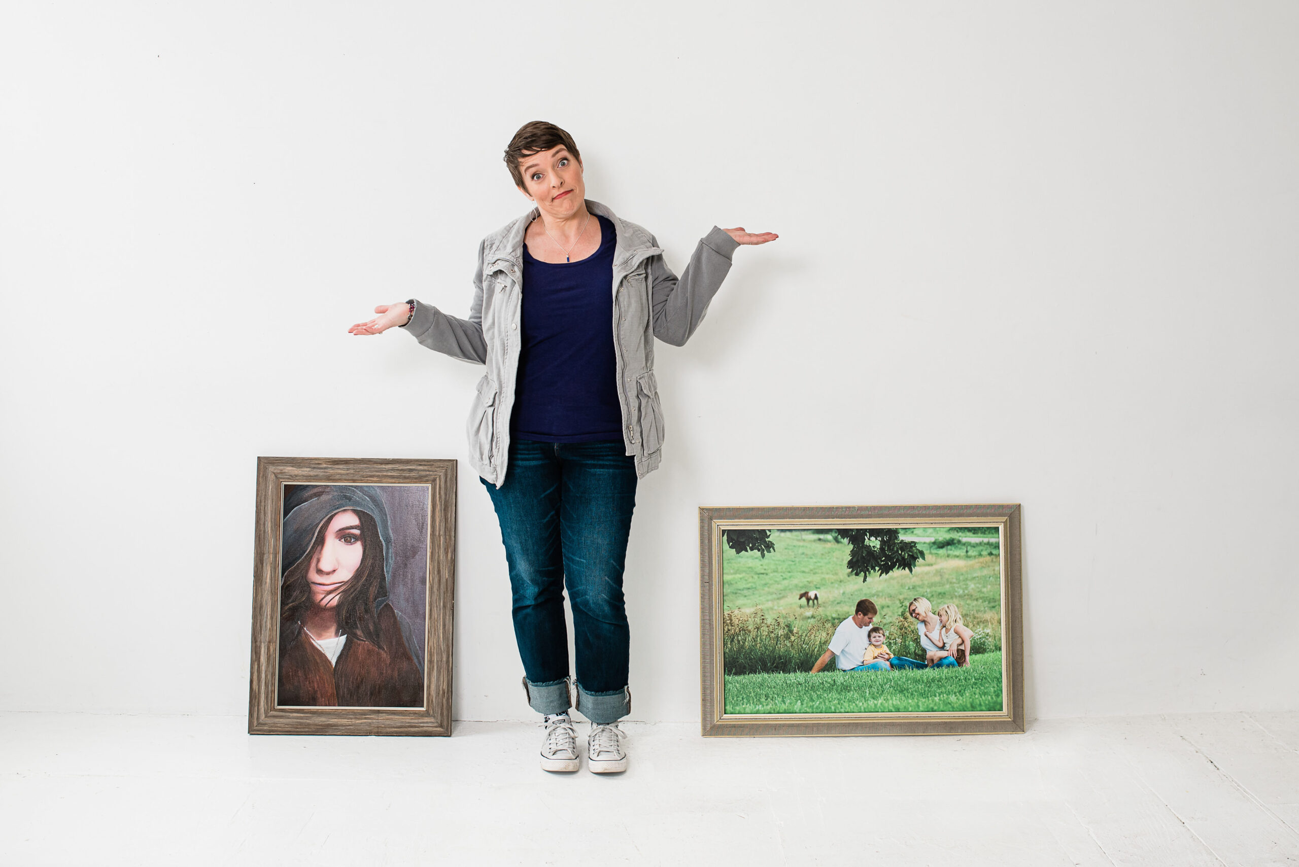 Woman showing why not with framed portraits